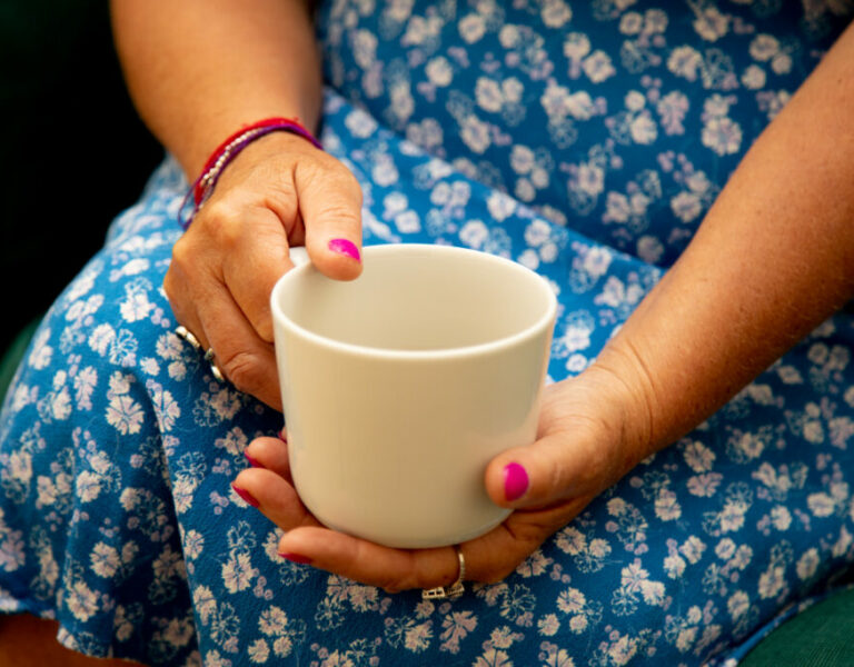 A stock image showing a woman with a cup of tea
