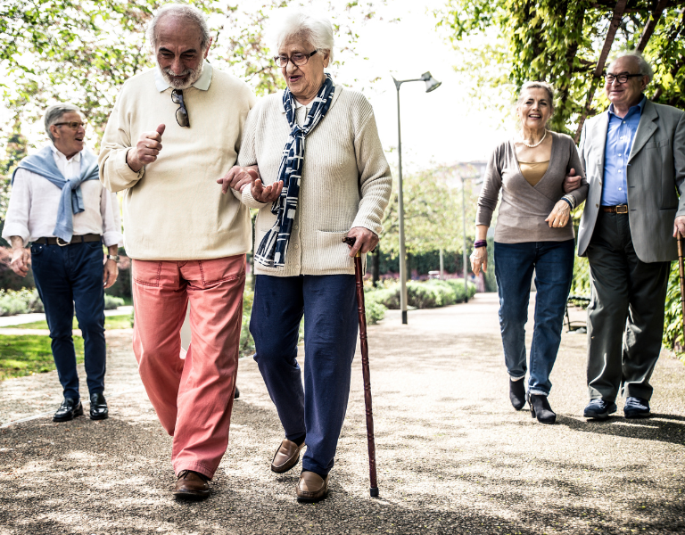 A stock photo of a group of older people enjoying a walk.