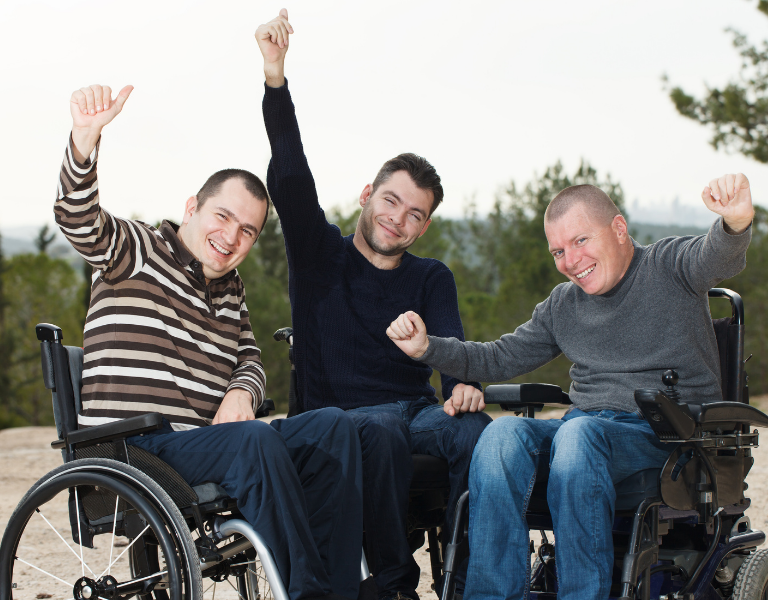 A stock photo of three young men in their wheelchairs.