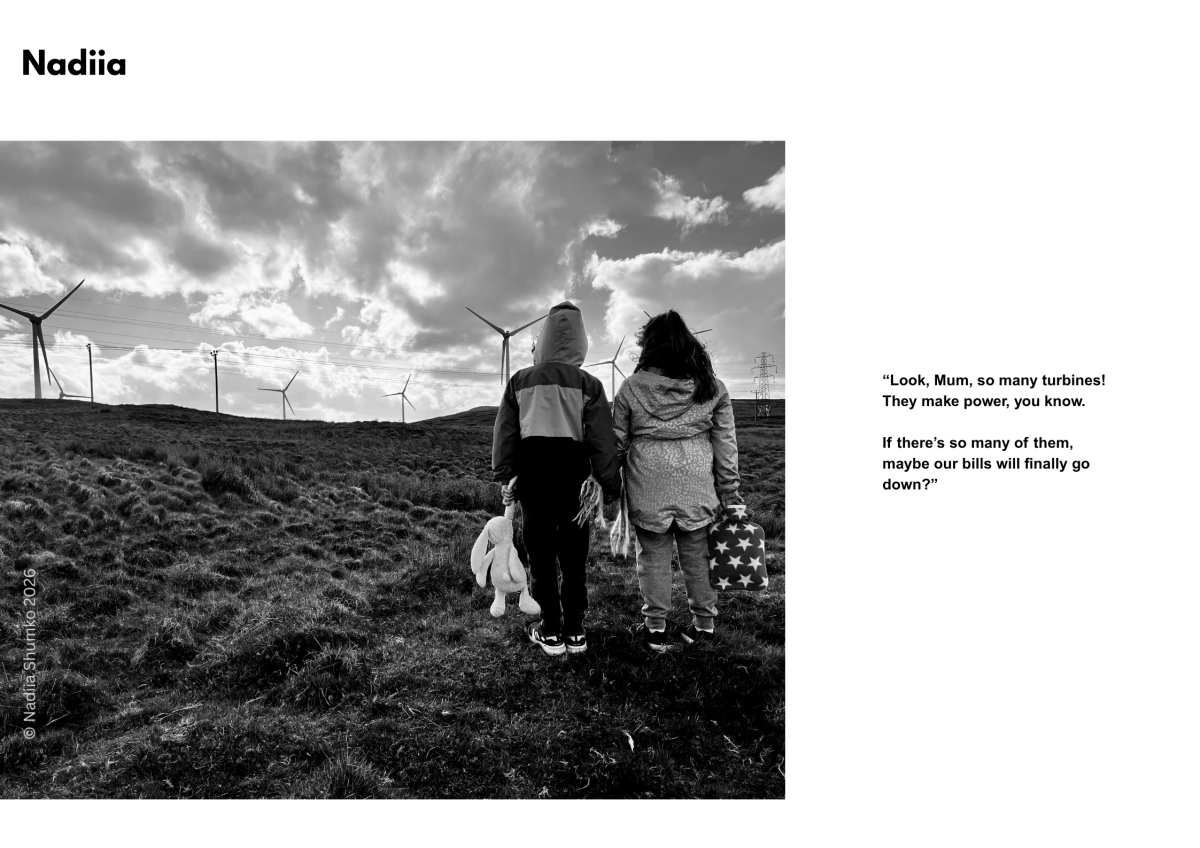 A photograph of a mother and daughter looking at a wind turbine in a rural landscape. Caption says“Look, Mum, so many turbines! They make power, you know. If there’s so many of them, maybe our bills will finally go down?”